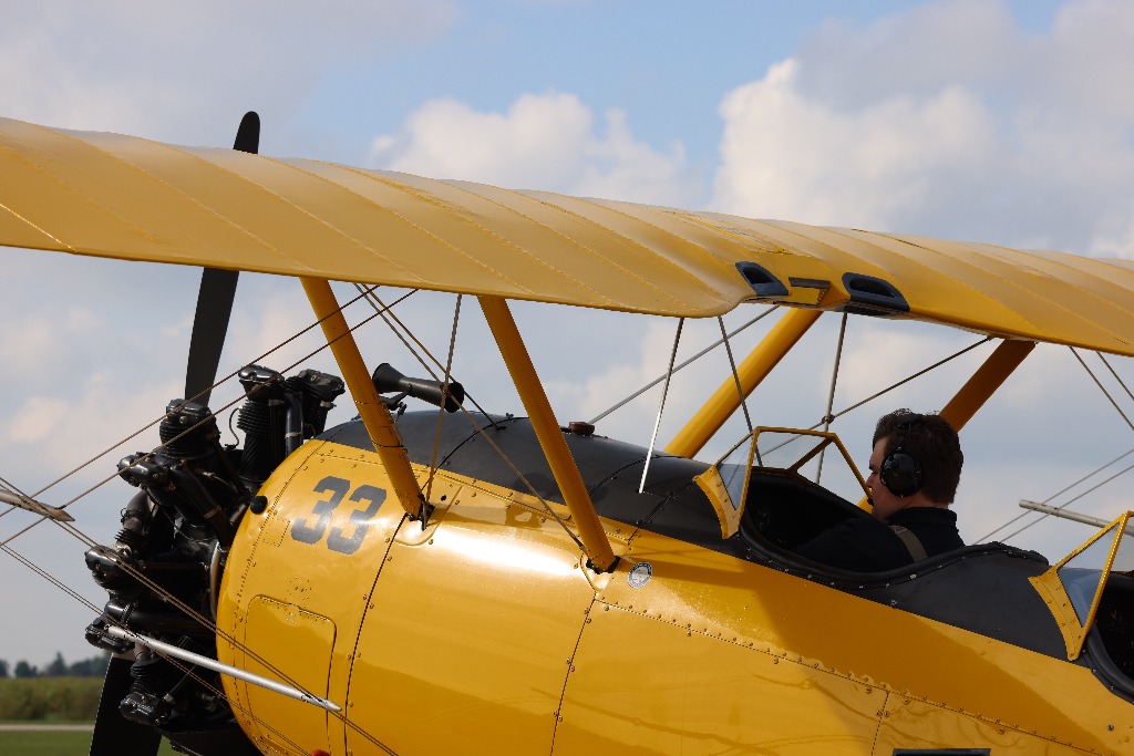 Classic yellow biplane profile with radial engine